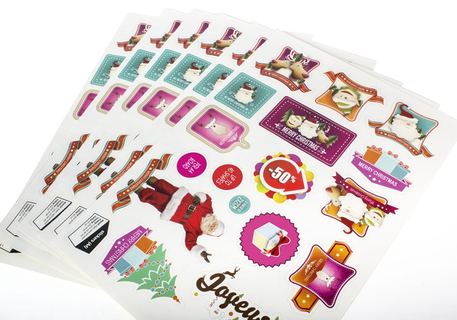 A variety of Christmas stickers on a sheet.